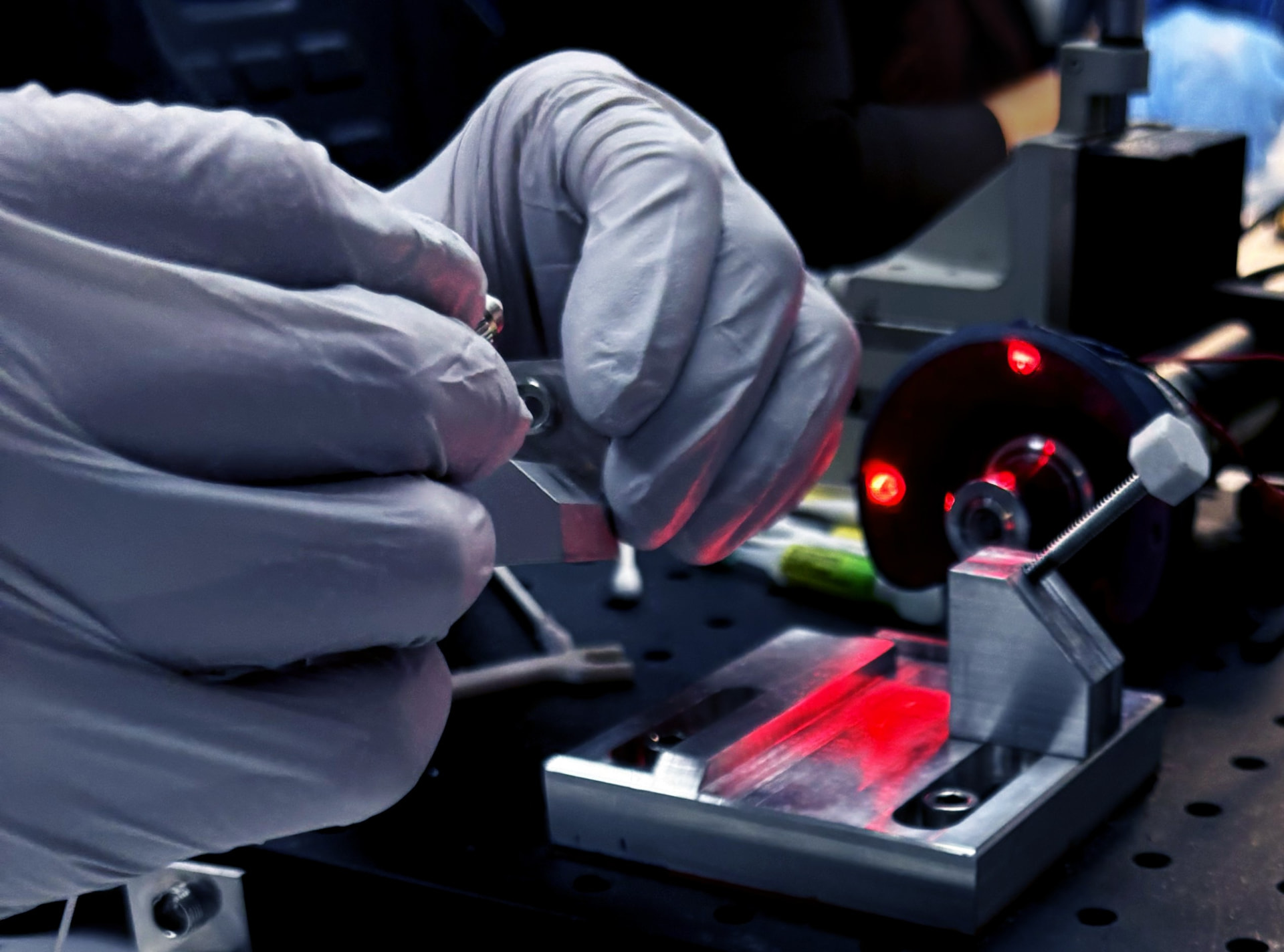 Technician aligning an optical assembly under laser light